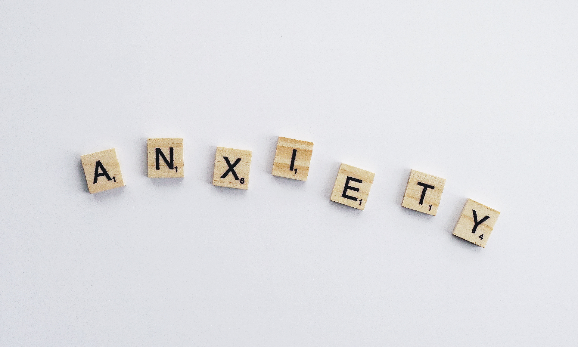 Image of "anxiety spelled out in scrabble letters. Representing the anxiety symptoms you could be feeling. However with therapy for anxiety in Reading and Wyomissing, PA you can feel better!