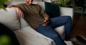 Image of a man on his phone & smiling. Representing the positive outcome for CBT for depression in Reading, PA. There are many benefits to starting CBT therapy or cognitive behavioral therapy in Wyomissing & Reading, PA.